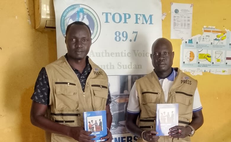 Top FM receives donation of three press jackets from UJoSS